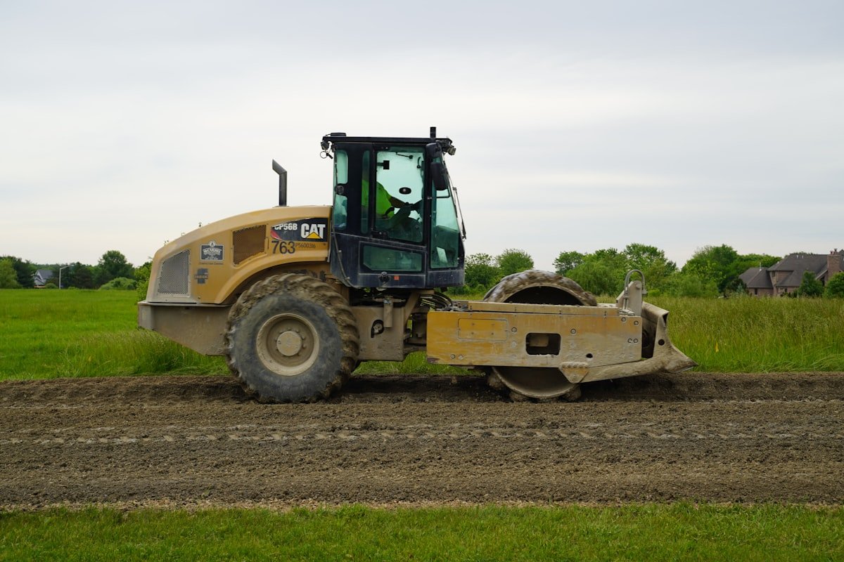 Soil compactor roller working on a construction site