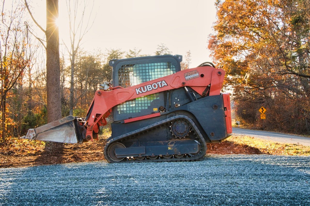 Skid steer loader with bucket attachment on a job site